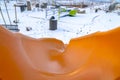 Orange slide on snowy playground in Eagle Mountain