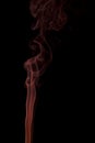 Orange smoke swirling on a black background