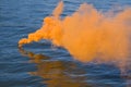 Orange smoke on water Royalty Free Stock Photo