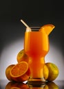 Orange smoothie decorated with fresh oranges Royalty Free Stock Photo