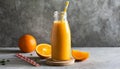 Orange smoothie in glass bottle with paper straw. Tasty and healthy drink. Summer beverage Royalty Free Stock Photo