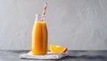 Orange smoothie in glass bottle with paper straw. Tasty and healthy drink. Summer beverage Royalty Free Stock Photo