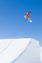 Orange Snowboarder Leaving Ramp