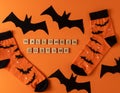 Orange socks with bats. Clothing costume for Halloween party. Cheerful bright multicolored sock top view.