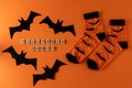 Orange socks with bats. Clothing costume for Halloween party. Cheerful bright multicolored sock top view.