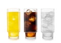 Orange soft drink with cola and lemonade soda on white background with ice cubes Royalty Free Stock Photo