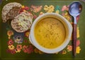 Orange soup and a rustic wholemeal bread roll Royalty Free Stock Photo