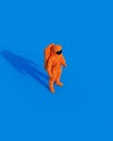 Orange spaceman astronaut retro space suit 90s 80s sunlight gen z blue background