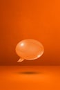 Orange speech bubble on concrete wall vertical background Royalty Free Stock Photo