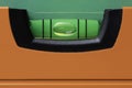 Orange spirit level with green bubble Royalty Free Stock Photo