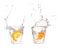 orange splashing into glass of water on white Royalty Free Stock Photo