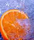 Orange splashing water Royalty Free Stock Photo