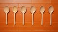 Orange Spoon Ornaments On Beige Tile: Political Commentary In Stereotype Photography