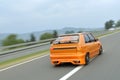 Orange sport car drive fast Royalty Free Stock Photo