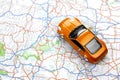 Orange sports car toy on map Royalty Free Stock Photo