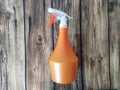 Orange spray bottle on wooden table background Royalty Free Stock Photo