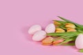 Orange spring flower tulips with Easter eggs on pink background Royalty Free Stock Photo