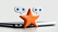 Orange star symbol over smartphone with speech bubbles, white isolate background Royalty Free Stock Photo