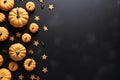 Orange stars and small pumpkins on black background, top view, copy space. Halloween, Thanksgiving holiday concept Royalty Free Stock Photo