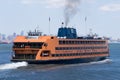 Orange Staten Island Ferry boat with skyline of downtown Manhattan New York Royalty Free Stock Photo