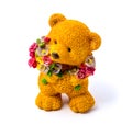 Orange statuette of a bear with flowers isolated on a white background