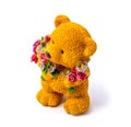 Orange statuette of a bear with flowers isolated on a white background