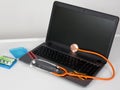 Orange stethoscope on laptop on laboratory desk table grey background Royalty Free Stock Photo