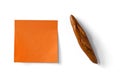 Orange sticky note and figure of french loaf