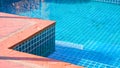 Orange stone tile edge and blue swimming pool in vintage style and perspective side view Royalty Free Stock Photo