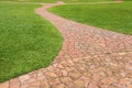 Orange stone walkway with green grass in park. Abstract background Royalty Free Stock Photo