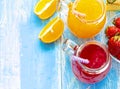 Orange and strawberry juice in glass on old wooden  blue table Royalty Free Stock Photo