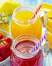 Orange and strawberry juice in glass on old wooden  blue table Royalty Free Stock Photo