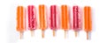 Orange and strawberry popsicles isolated on white background. Royalty Free Stock Photo