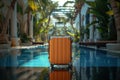 Orange suitcase by the pool in a tropical hotel atrium.