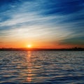 Orange sunrise over river in deep blue sky Royalty Free Stock Photo