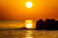 Orange sunrise over the rocky coast of the Mediterranean Sea Royalty Free Stock Photo