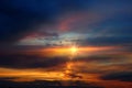 Orange sunse on night blue sky dramatic clouds and sun flres