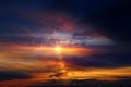 Orange sunse on night blue sky dramatic clouds and sun flres