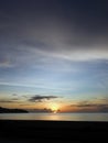 orange sunset with clouds over the sea at Pantai Merdeka