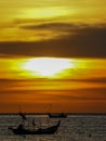 an orange sunset with fishing boat silhouette Royalty Free Stock Photo