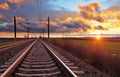 Orange sunset in low clouds over railroad Royalty Free Stock Photo