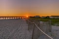 Orange sunset at a NC beach where the coastline goes west southwest