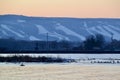 Orange sunset over the Blue Mountains with lights along ski hills Royalty Free Stock Photo