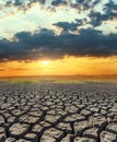 sunset over drought land. global warming concept Royalty Free Stock Photo