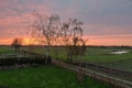 Orange sunset over farmland and trees at the Dutch countryside near Echt, the Netherlands Royalty Free Stock Photo