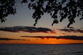 Orange sunset over horizon of lake water at dusk in the evening Royalty Free Stock Photo