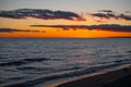 Orange sunset over horizon of lake water at dusk in the evening Royalty Free Stock Photo