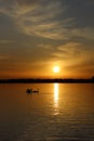 Orange sunset over the lake, beautiful nature background, floating swans, landscape, bright sky Royalty Free Stock Photo