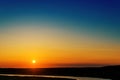 Orange sunset over river and blue sky Royalty Free Stock Photo