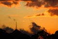 Orange sunset with rain and clouds of several colors